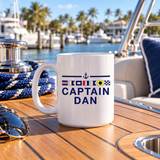Personalized Captain Dan 15 oz ceramic mug displayed on a boat deck