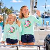 Colorful flamingo and coastal botanical Christmas wreath on kids’ performance shirt