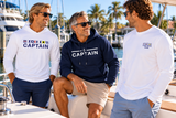 Boating friends wearing nautical shirts and Captain hoodie at a marina