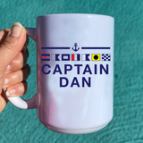 Personalized Captain Dan ceramic mug with nautical signal flags and anchor